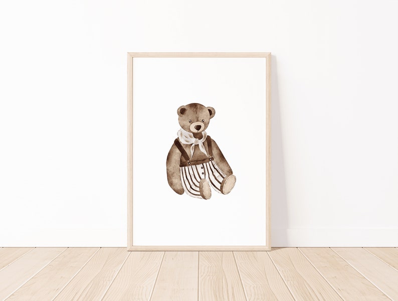 May include: A brown teddy bear wearing a white and black striped outfit with a brown belt and a white scarf. The bear is sitting on a white background.