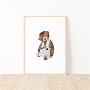 May include: A watercolor illustration of a brown teddy bear wearing blue and white striped overalls. The bear is sitting with its head tilted down and its paws crossed.