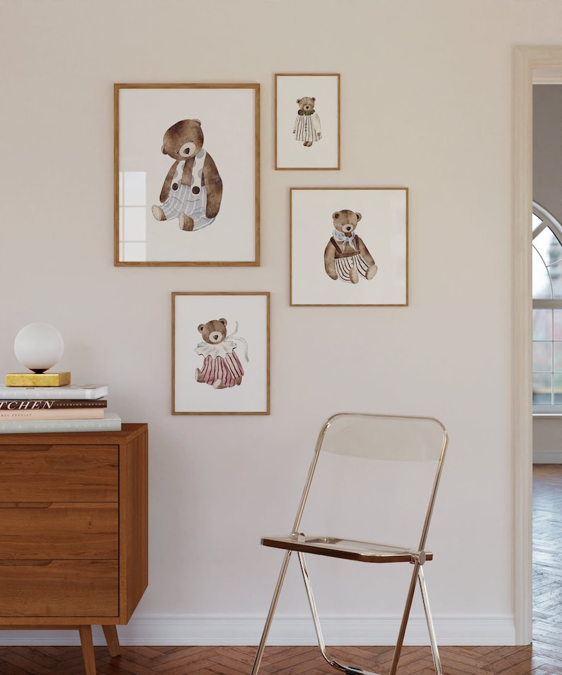 May include: Four framed watercolor illustrations of brown teddy bears wearing different outfits. The bears are all sitting down and have a whimsical, childlike style. The frames are all wooden and have a natural finish.