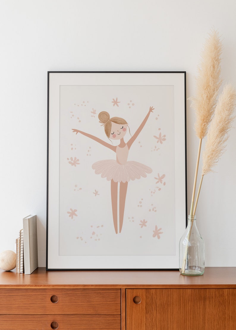 May include: A framed illustration of a ballerina in a pink tutu with her arms outstretched. The background is a light pink with small pink flowers and dots.