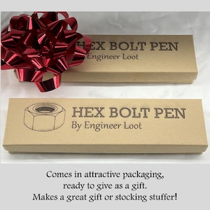 May include: A brown cardboard box with the text "HEX BOLT PEN By Engineer Loot" printed on it. The box is wrapped in red ribbon and is ready to be given as a gift.