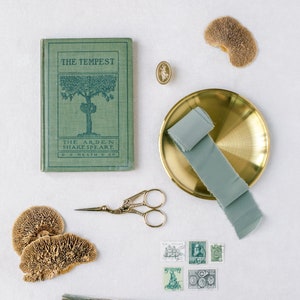 Earthy Sage Styling Kit for Wedding Photographers Green Antique Book Curated Luxury Organic Stamps Ring Box Flat Lay Scissors Tassel