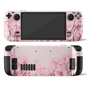 May include: A handheld gaming console with a pink floral design. The front features a black screen, buttons, and control sticks. The back of the console also has the same pink floral pattern and black accents.