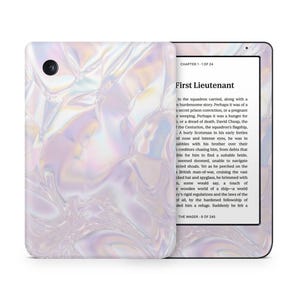 May include: A white and iridescent Kindle e-reader with a digital book cover displaying the text "First Lieutenant" and "Chapter 1 of 24".
