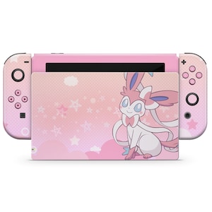 Könnte beinhalten: Rosa Nintendo Switch Konsole mit einer benutzerdefinierten Haut, die ein Cartoon-Bild eines rosa und weißen Pokémon mit einer Schleife zeigt. Der Hintergrund ist ein rosa und weißes Muster mit Sternen und Wolken.