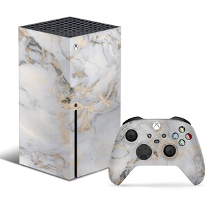 May include: A white and gold marble patterned skin for an Xbox Series X console and controller.