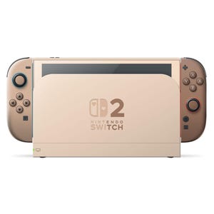 Puede incluir: Una consola Nintendo Switch de color beige con mandos Joy-Con a juego. La consola está acoplada en una estación de carga beige. El logotipo de Nintendo Switch es visible en la parte frontal de la base.