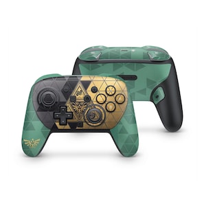 May include: A wireless video game controller featuring a green and black geometric pattern. The front faceplate displays a gold and black triangular emblem with intricate line art. A gold Triforce symbol is printed on the left handle.