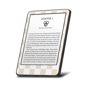 May include: A black and white e-reader displaying the first chapter of a fantasy novel titled "The Flame of Tar Valon". The text describes the Wheel of Time and the beginning of a new age.