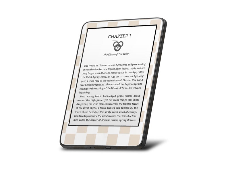 May include: A black and white e-reader displaying the first chapter of a fantasy novel titled "The Flame of Tar Valon". The text describes the Wheel of Time and the beginning of a new age.