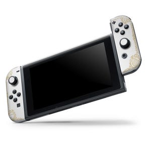 May include: A white Nintendo Switch console with gold accents and a matching Joy-Con controller. The console is in handheld mode with the screen displaying a black screen.