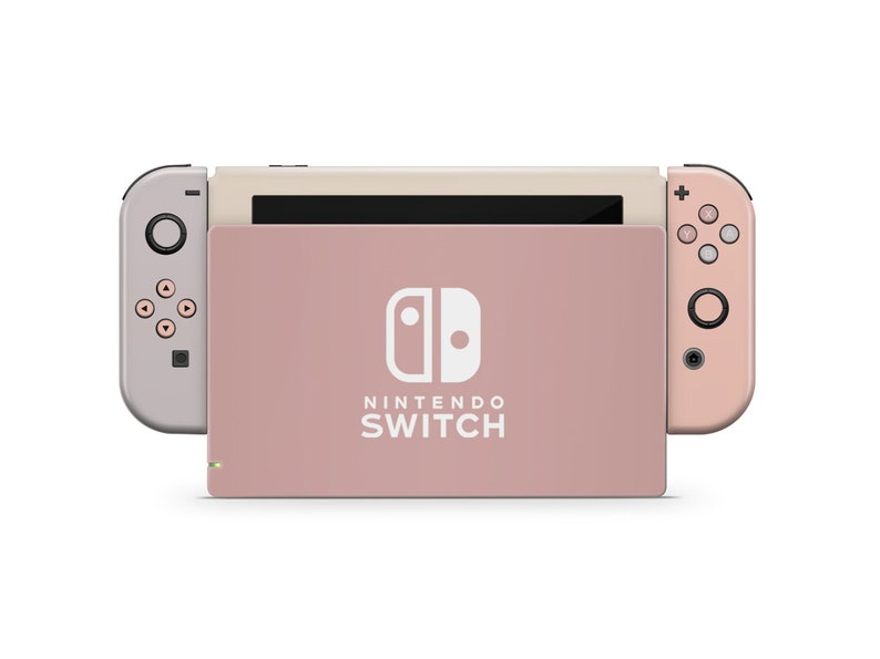 May include: A pink Nintendo Switch console with white Joy-Cons and the Nintendo Switch logo on the front.
