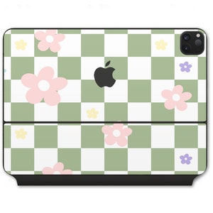 May include: A green and white checkered phone case with pink and yellow flowers. The case has a black Apple logo in the centre.