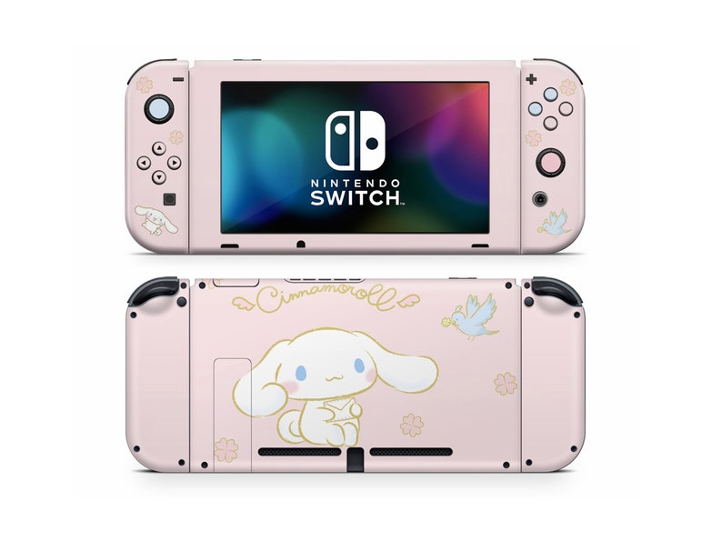 May include: Pink Nintendo Switch console with a Cinnamoroll character design. The console features a white dog with floppy ears and a blue bird. The text "Cinnamoroll" is written in cursive on the back of the console.