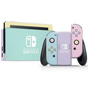 May include: A pastel blue and purple Nintendo Switch console with a white heart design and the text "Nintendo Switch". The console is attached to a pink Joy-Con controller.