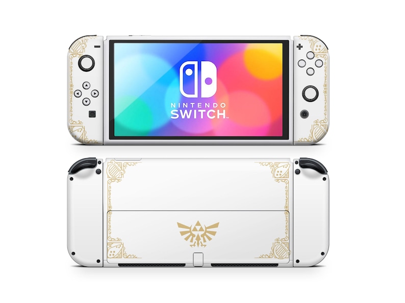 May include: White Nintendo Switch console with a gold and white Zelda themed design. The console has a gold border and a Triforce symbol in the center. The screen displays the Nintendo Switch logo.