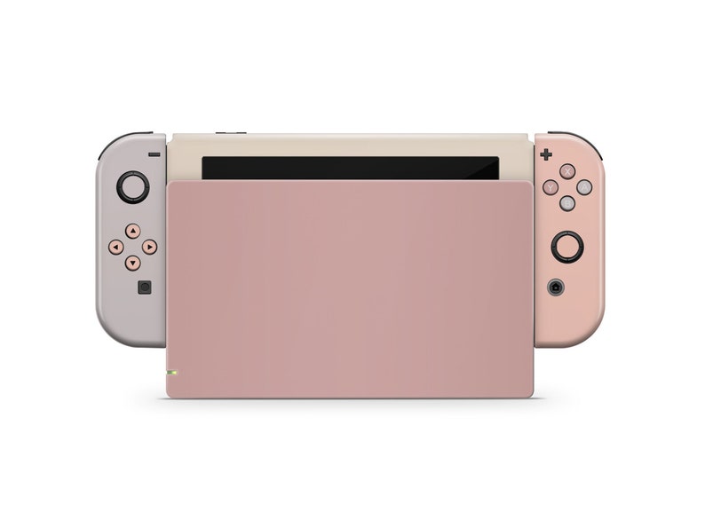 May include: A pink and beige Nintendo Switch console with detachable controllers. The console is closed and the screen is off.