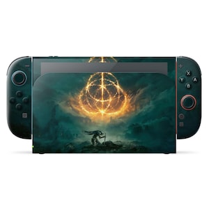 May include: A Nintendo Switch console with a custom skin featuring artwork from the video game Elden Ring. The skin displays a dramatic scene with a glowing golden symbol and a kneeling figure against a dark, atmospheric background.