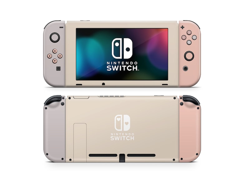 May include: A pale pink and beige Nintendo Switch console with a white Nintendo Switch logo and the text "NINTENDO SWITCH" on the front. The console is in a closed position.