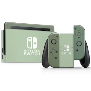 以下が含まれることがあります： ミントグリーンのNintendo Switch本体と、お揃いのJoy-Conコントローラー。本体とコントローラーには、ハートのデザインが施されたNintendo Switchのロゴが入っています。Joy-Conは、より濃い緑色です。