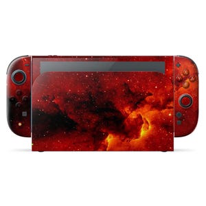 May include: A Nintendo Switch console with a vibrant red and orange nebula design. The Joy-Con controllers and the main console body feature a detailed cosmic pattern, creating a visually striking aesthetic. The buttons and controls are visible.