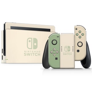 以下が含まれることがあります： クリーム色のニンテンドースイッチ本体と、それに合わせたJoy-Conコントローラー。Joy-Conコントローラーは背面に緑色のアクセントがある。本体にはニンテンドースイッチのロゴとテキストが前面に表示されている。