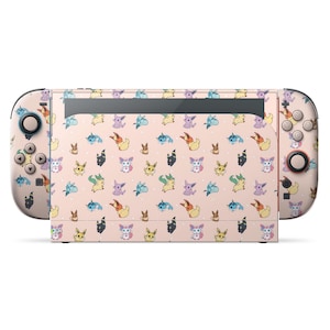 May include: A Nintendo Switch console with a custom skin. The skin has a repeating pattern of colourful cartoon characters on a light pink background. The Joy-Con controllers and screen area are covered in the design.