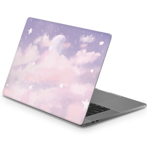 May include: A laptop computer with a pink and purple sky with white stars and a moon design on the lid.