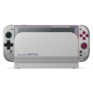 May include: A white Nintendo Switch console with attached controllers. The console has a gray screen with the text "DOT MATRIX WITH STEREO SOUND" at the top. The controllers have pink and blue buttons. The console's base has the text "Nintendo SWITCH" in purple.