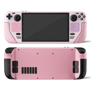 May include: A pink handheld gaming console with black buttons and a black screen. The console has a pink and black design with a textured surface. The back of the console is also pink with black accents.
