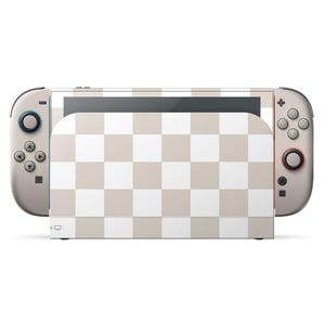 May include: A Nintendo Switch console with a beige and white checkered pattern on the screen and dock. The Joy-Con controllers are light gray with black buttons and red and blue accents.