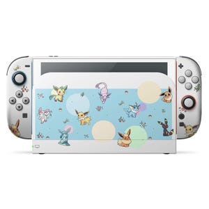 May include: A white Nintendo Switch console with attached controllers. The console features a design with various cartoon characters on a light blue background with beige circles. The controllers are white with character details.