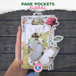 May include: A floral page pocket with a butterfly and rose embellishments. The pocket features a bee, floral patterns, and the text "PAGE POCKETS FLORAL". The design includes a layered effect with various paper elements.