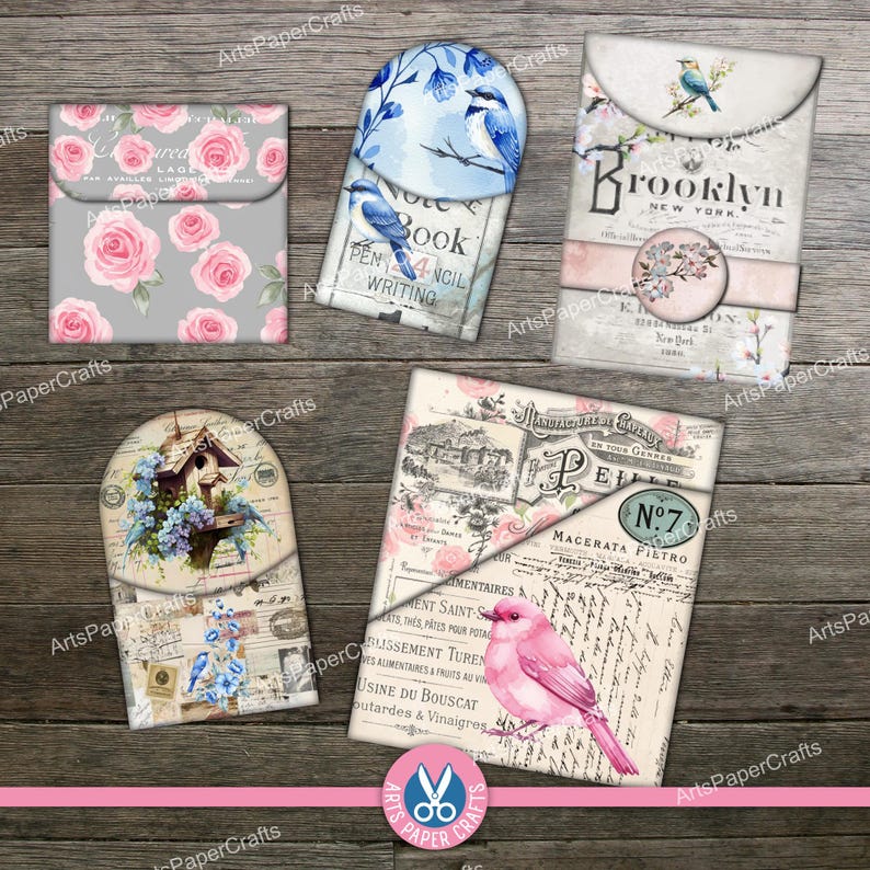 May include: A collection of five decorative paper envelopes featuring various designs including pink roses on a gray background, blue birds on a white background, a Brooklyn-themed envelope, a birdhouse illustration, and a pink bird on vintage script.
