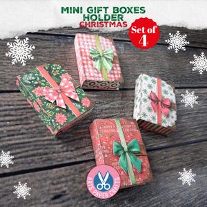 May include: A set of four rectangular mini gift boxes featuring Christmas-themed patterns including poinsettias, snowflakes, and holiday motifs. Each box is decorated with a printed ribbon and a bow. Text on the image reads MINI GIFT BOXES HOLDER CHRISTMAS.