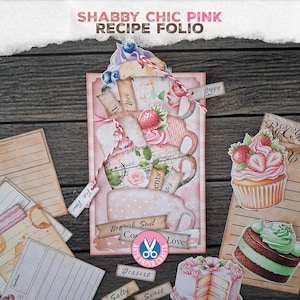 May include: A pink recipe folio with the text "Shabby Chic Pink Recipe Folio". The folio is decorated with images of teacups, strawberries, and cupcakes. Small tags with words like "Love" and "Dessert" are attached.