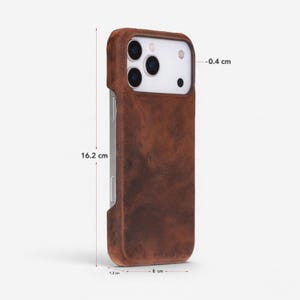 May include: A brown leather phone case, 16.2 cm tall, 8 cm wide, and 1.2 cm thick. The case has a distressed finish and a snug fit around the phone's camera and buttons. The case is 0.4 cm thick at the camera.