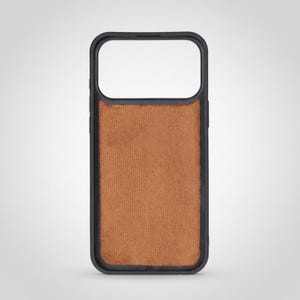 May include: A black phone case with a brown, textured back. The case has a rectangular shape with rounded corners and a cutout for the camera. The back of the case has a soft, suede-like appearance.