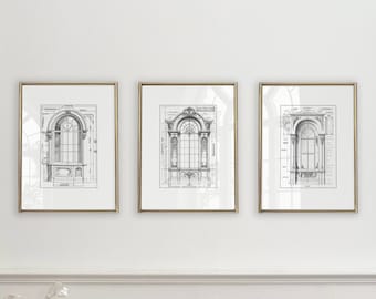 May include: Three black and white architectural drawings of windows framed in gold frames, hanging on a white wall. The drawings are in a minimalist style and feature intricate details of the windows.