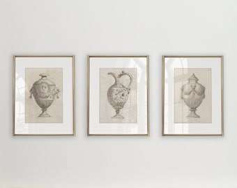May include: Three framed black and white line drawings of antique vases with ornate details. The frames are gold and the drawings are on a white background.