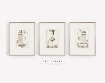 May include: Three framed black and white prints of architectural drawings. The prints are in silver frames and feature detailed drawings of columns and other architectural elements. The text "ART PRINTS" and "ANTIQUE ART COLLECTIVE" is below the frames.