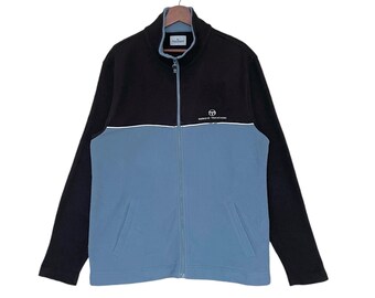 May include: A black and blue zip-up jacket with the text "Benetton" on the front.
