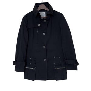 May include: A black, long-sleeved jacket with a button-up front and zippered pockets. The jacket has a collar and a slightly fitted silhouette.