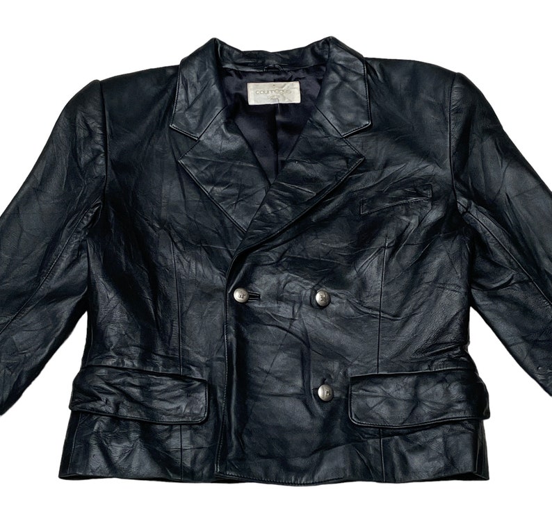 May include: A black leather double-breasted blazer with a  "Couturier" label.