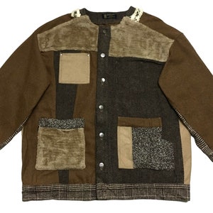May include: A brown patchwork jacket with a button front closure and multiple pockets. The jacket is made of different fabrics, including corduroy, tweed, and flannel.