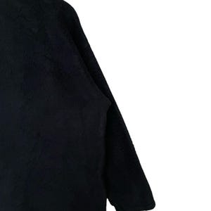 May include: A black long-sleeved sweater with a zipper closure.