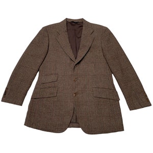 May include: A brown plaid blazer with a single-breasted closure and two button pockets.