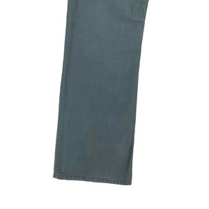 May include: A pair of dark blue denim trousers with a straight leg fit.