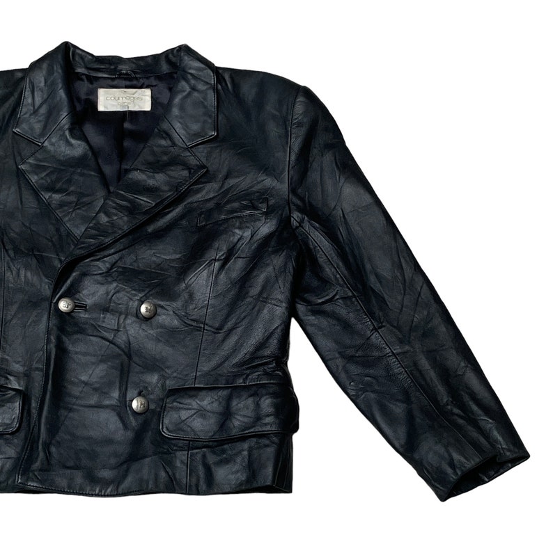May include: A black leather blazer with a double-breasted closure and two front pockets. The blazer has a  "Couturier" label on the inside.
