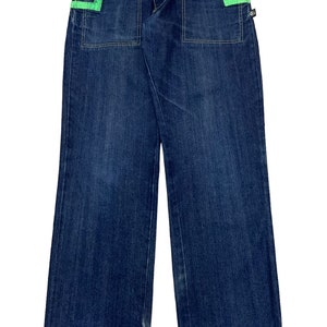 May include: Blue denim jeans with green trim on the pockets and waistband.